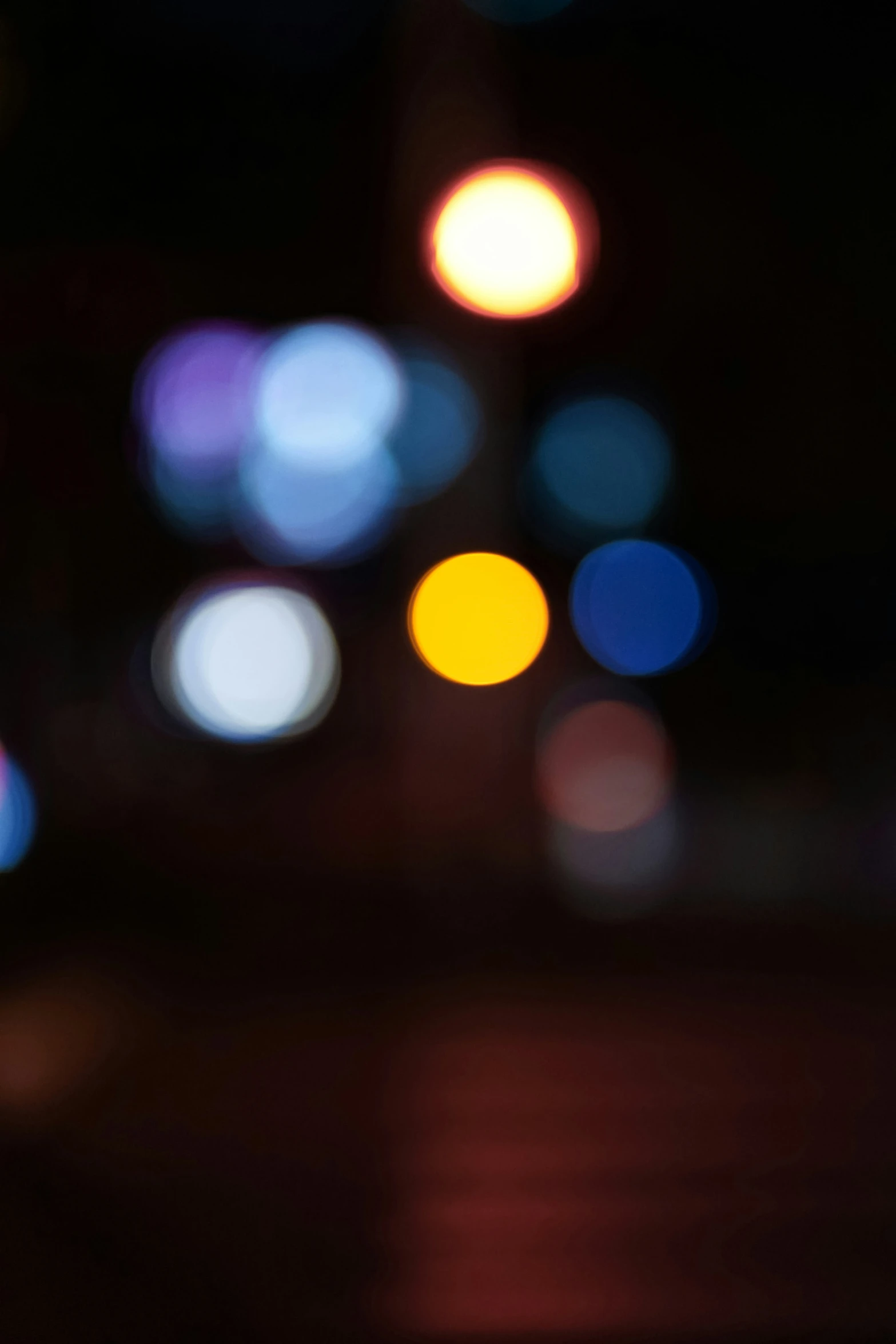 blurry po of streetlights and cars in the city