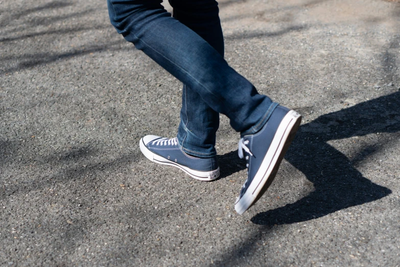 someone standing on the asphalt with their shoes down