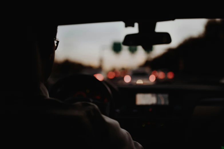 the inside of a car showing many cars driving on the street