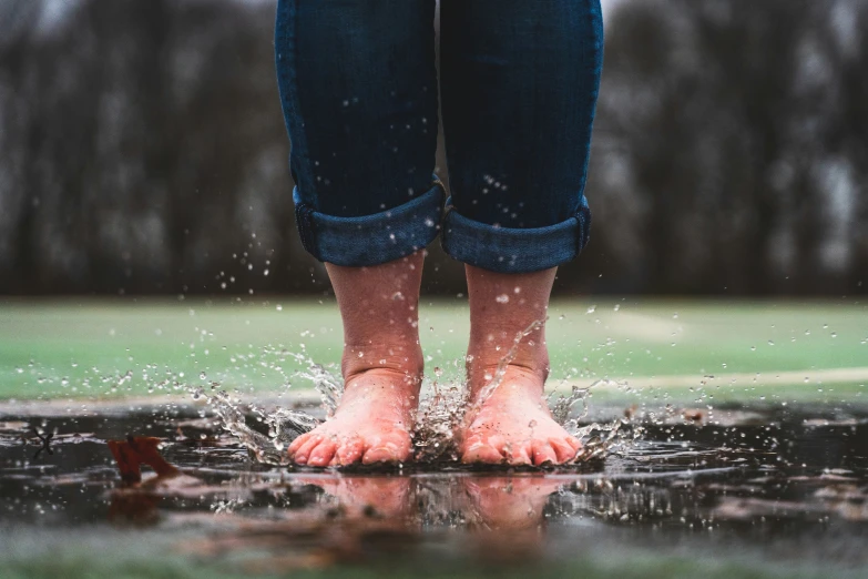 a person stepping out of the water with their bare feet