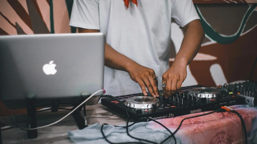 a dj is mixing his music at his desk