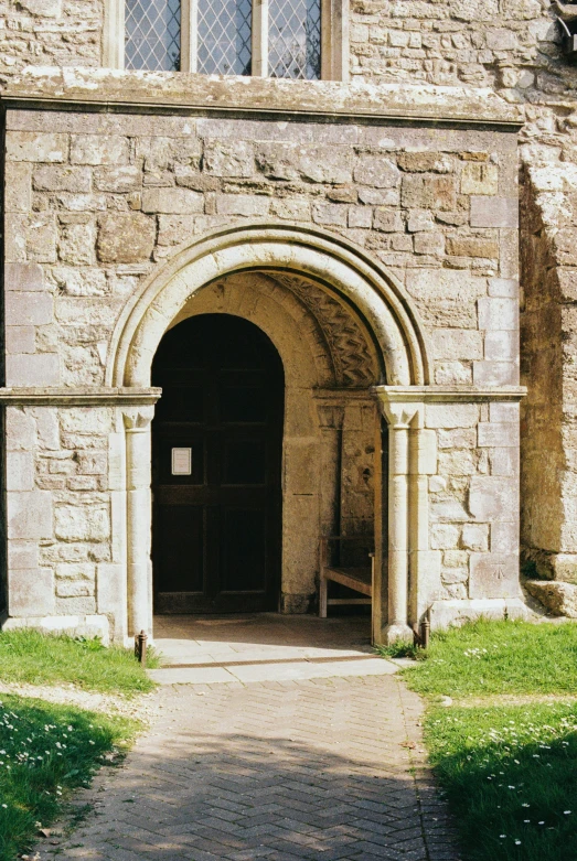 an old brick building has an arched stone entrance