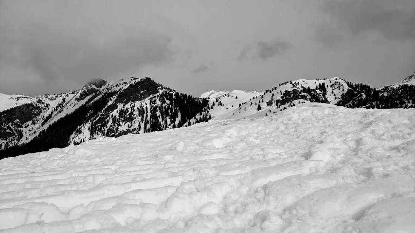 a person in snow gear is standing on top of the hill