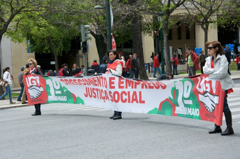 two people hold a banner that reads stop, press for democracy and no justice