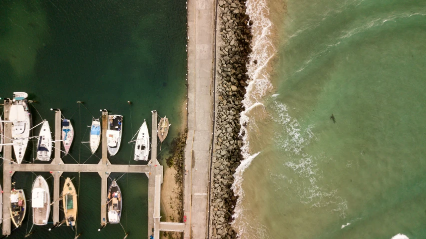 several boats are docked in a row on the dock