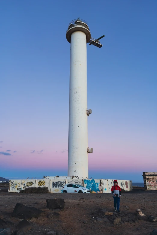 a man standing by the top of a tall tower