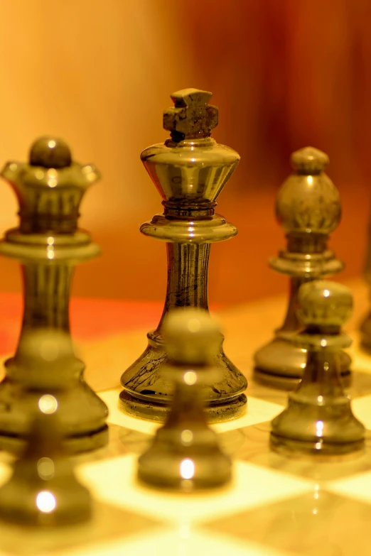 a chess board with a silver and gold chess game on it