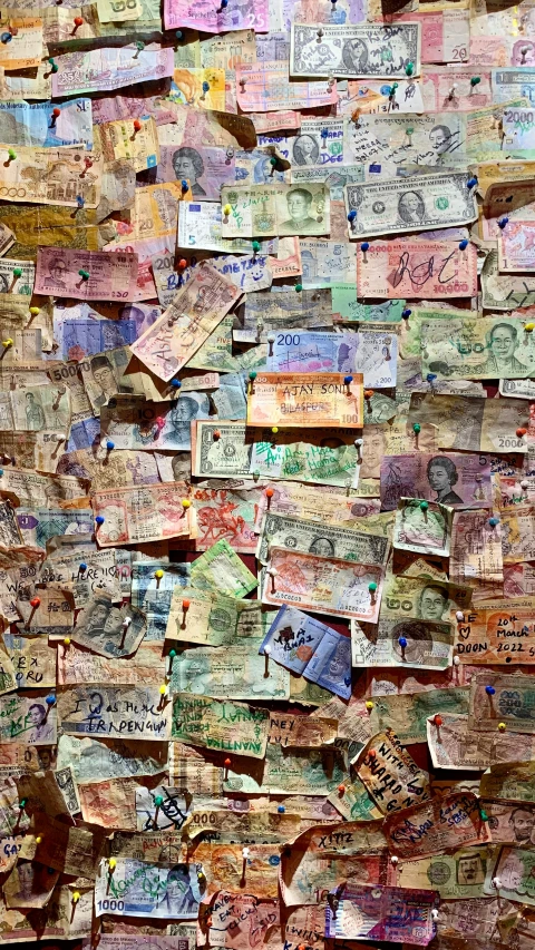 a wall made out of colorful money bills