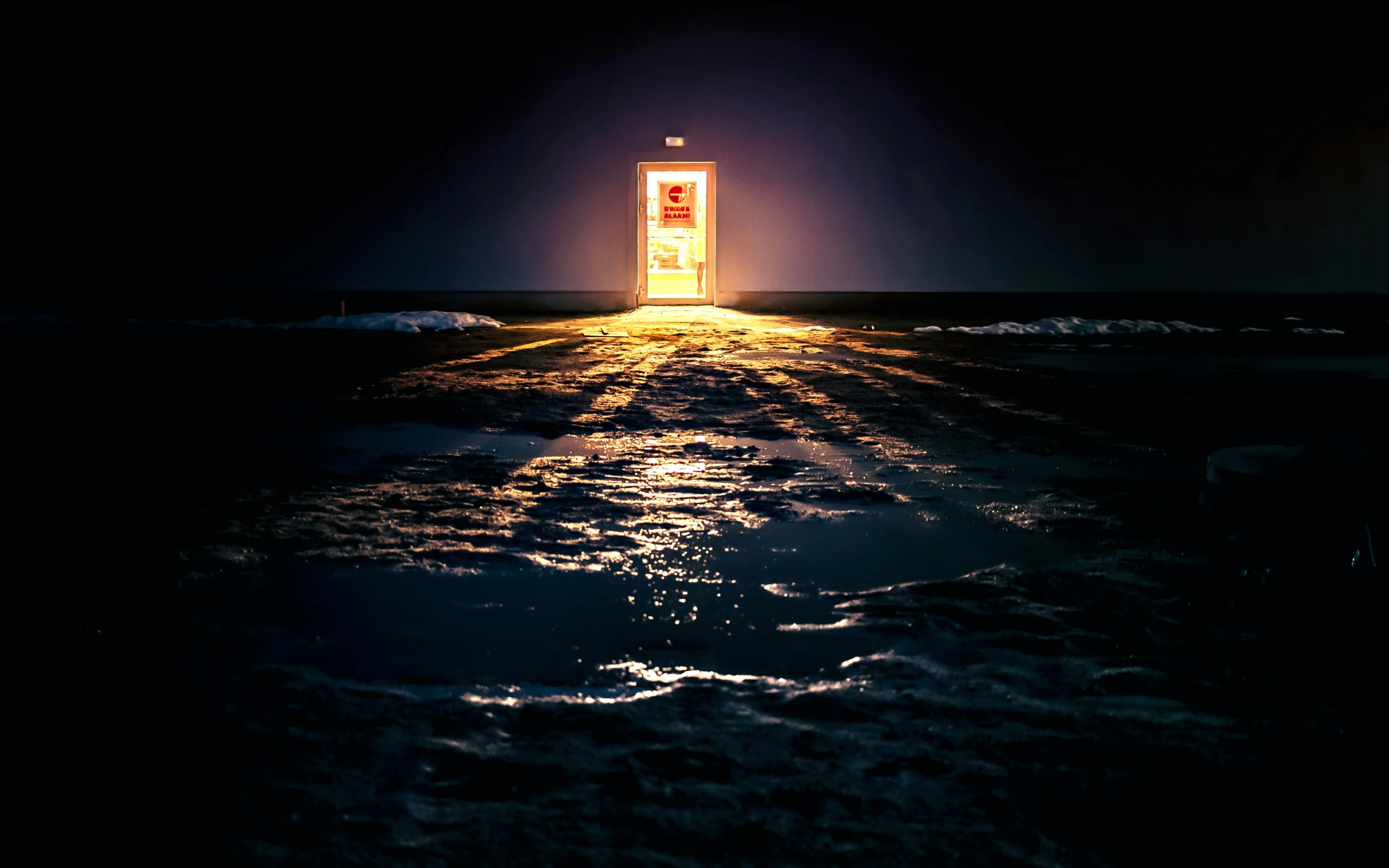 a large door in the middle of the ocean at night