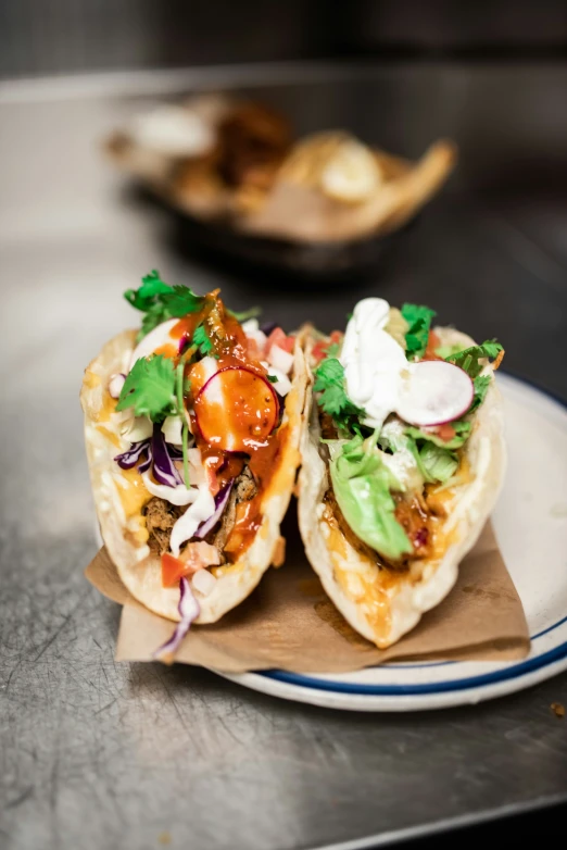 two tacos sitting on top of a plate covered in food