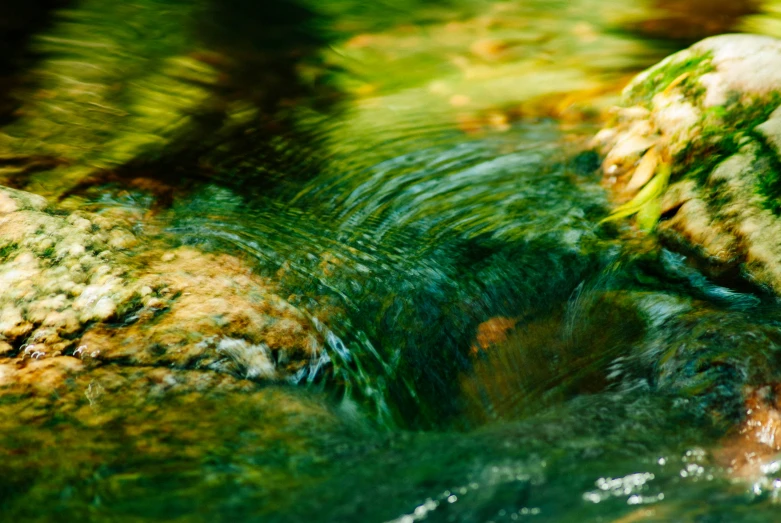 a blurry image of a closeup of rocks with water