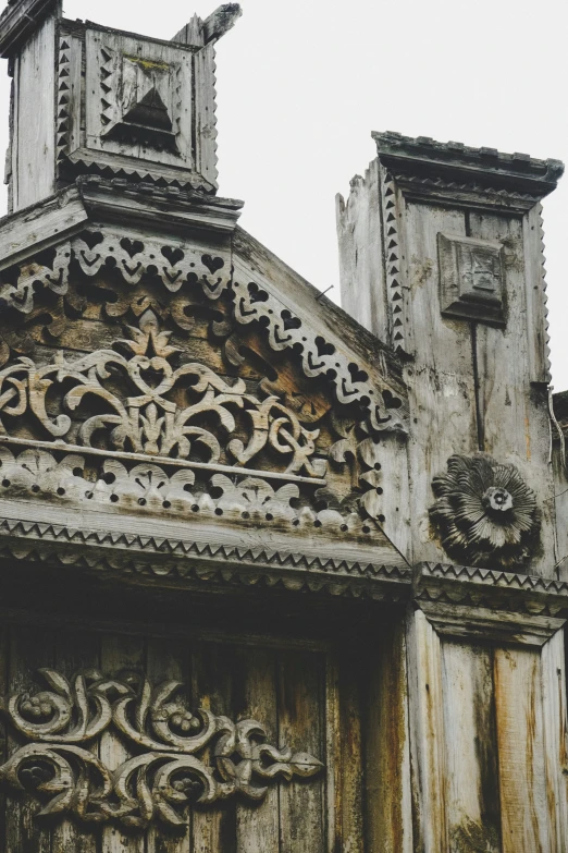 a stone building with some clock faces in the top