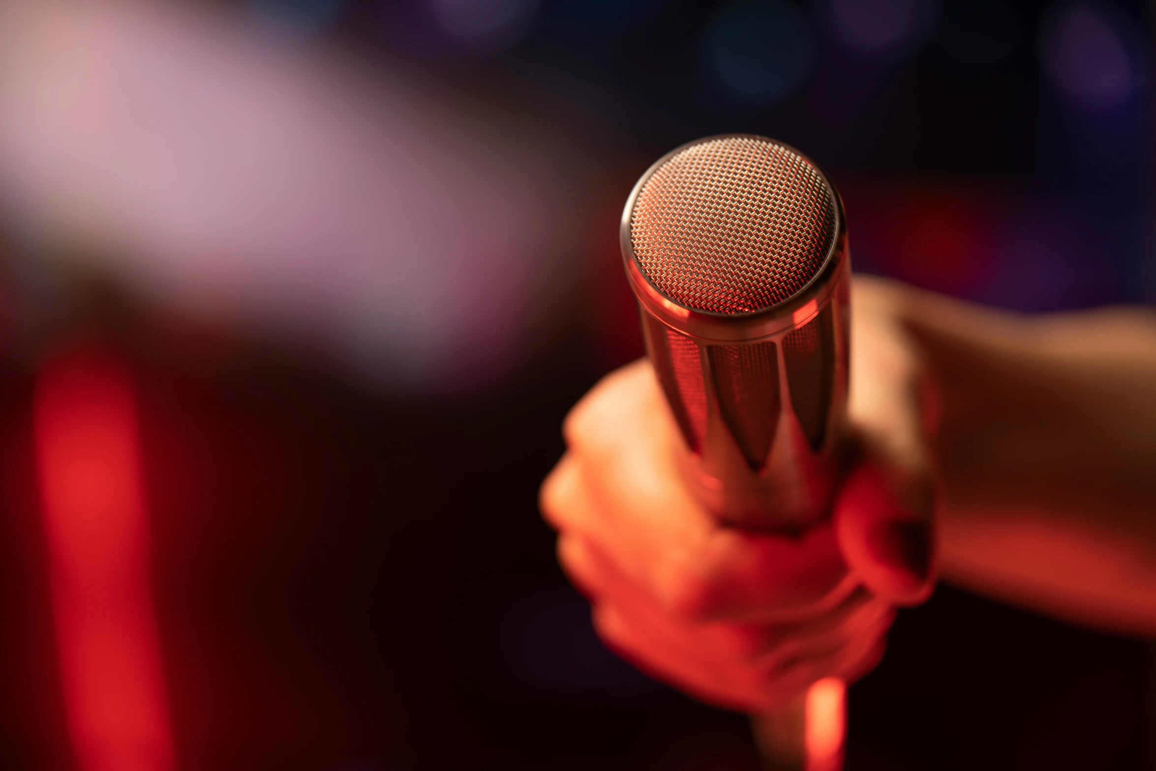 a woman holding a red microphone in her hands