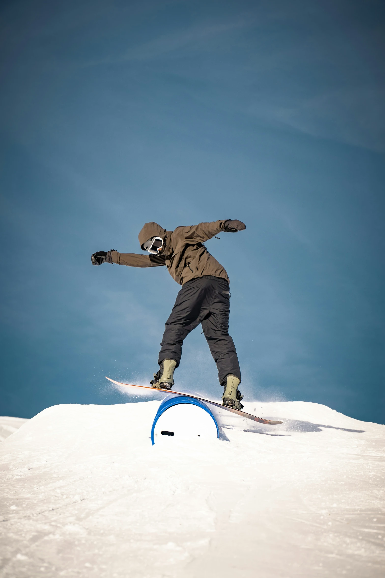 a man snowboarding off of a snowy cliff