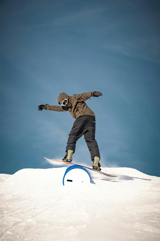 a man snowboarding off of a snowy cliff