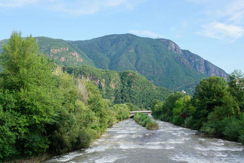 there is a river flowing between several hills