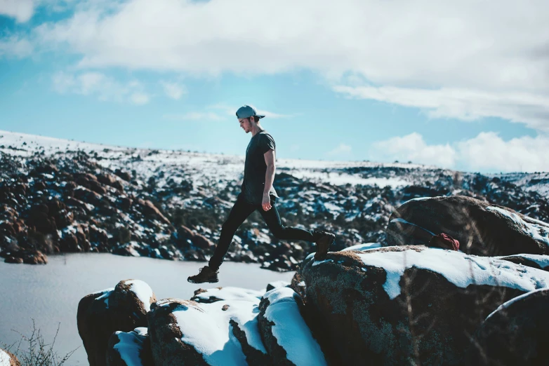 a man stands on a rocky mountain top