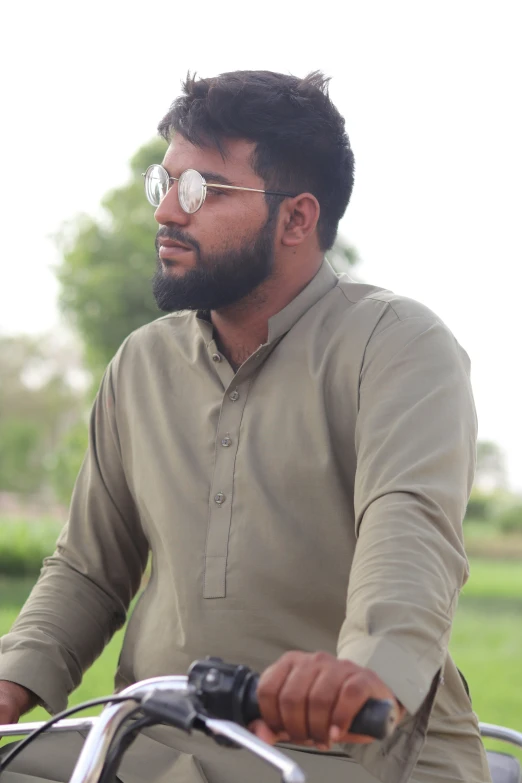 a man riding a bike with sunglasses on it