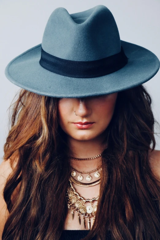 a girl wearing a blue hat and a chain