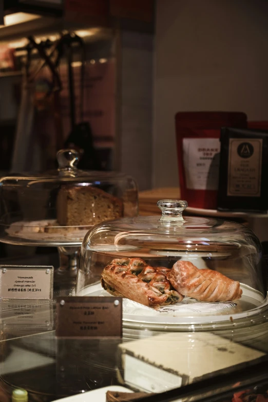 two pastry dishes are in the window of an bakery