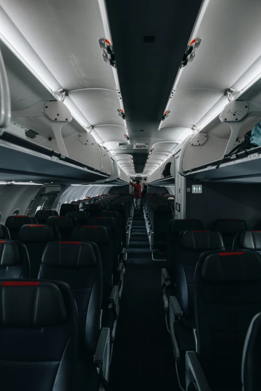 the inside of an airplane looking down on it's aisle