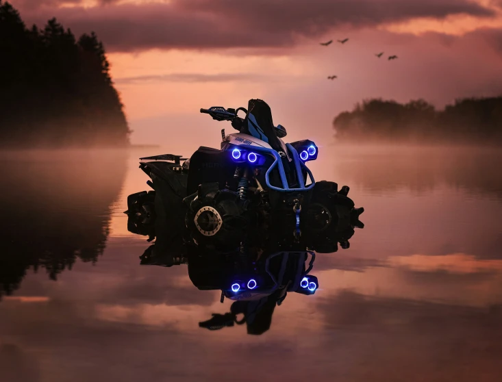 a motorcycle sitting on top of a lake in front of a purple sky