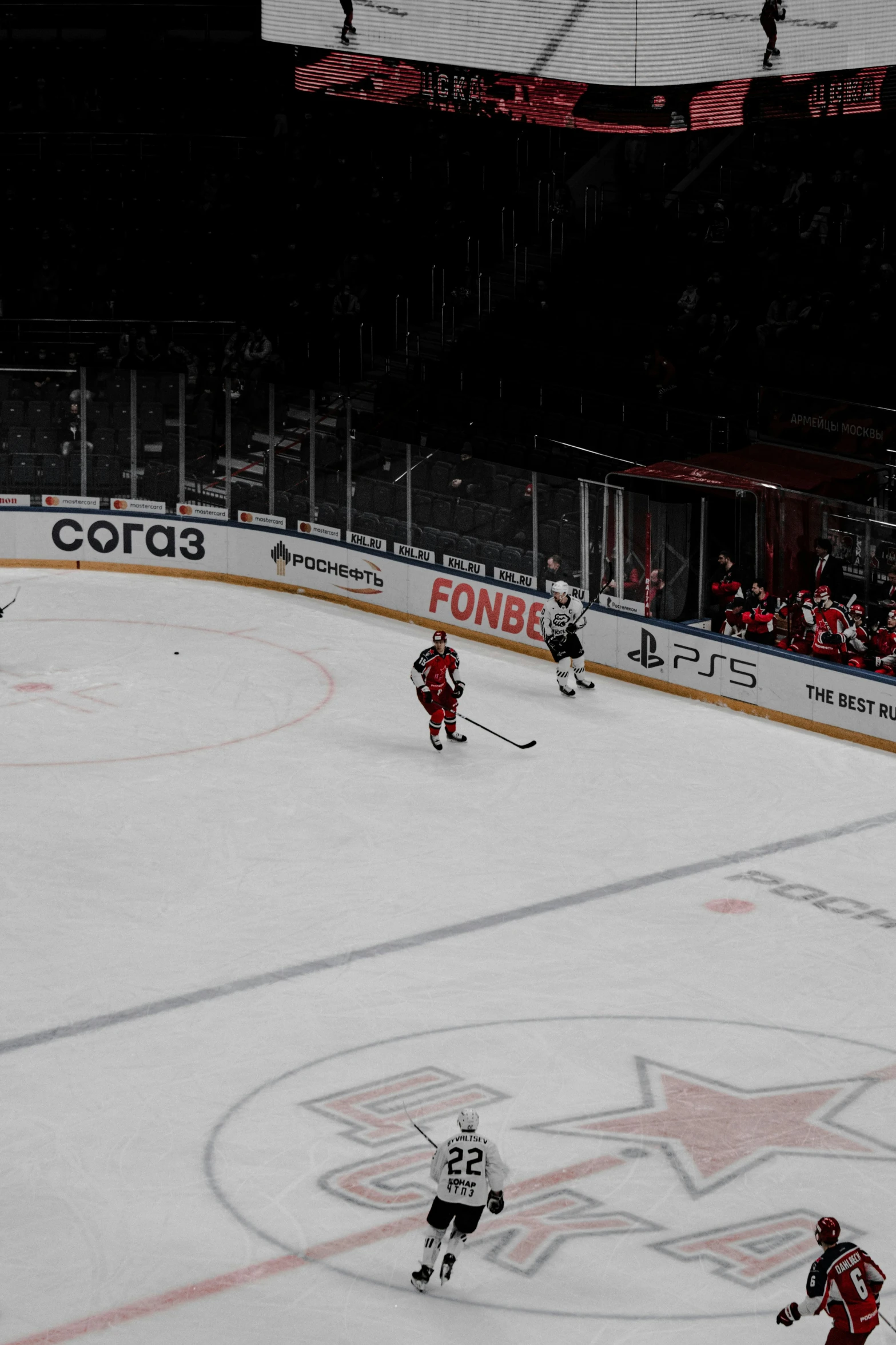 some hockey players are playing in a large arena