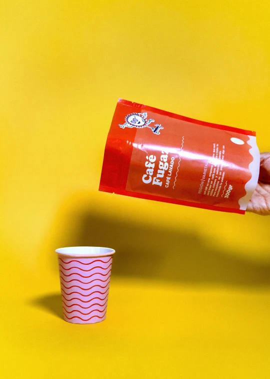 someone holding onto a plastic container and cup of coffee