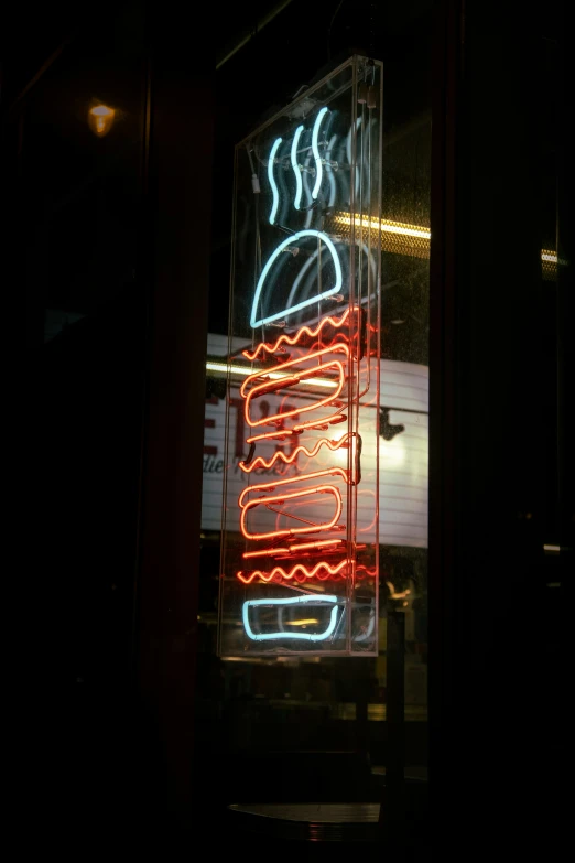 a neon sign displays donuts and other foods