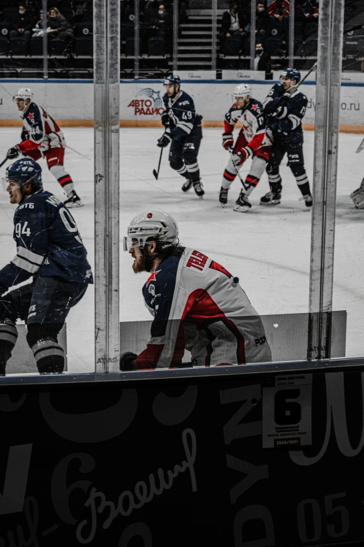 people are playing hockey as the hockey players in their uniforms are on ice