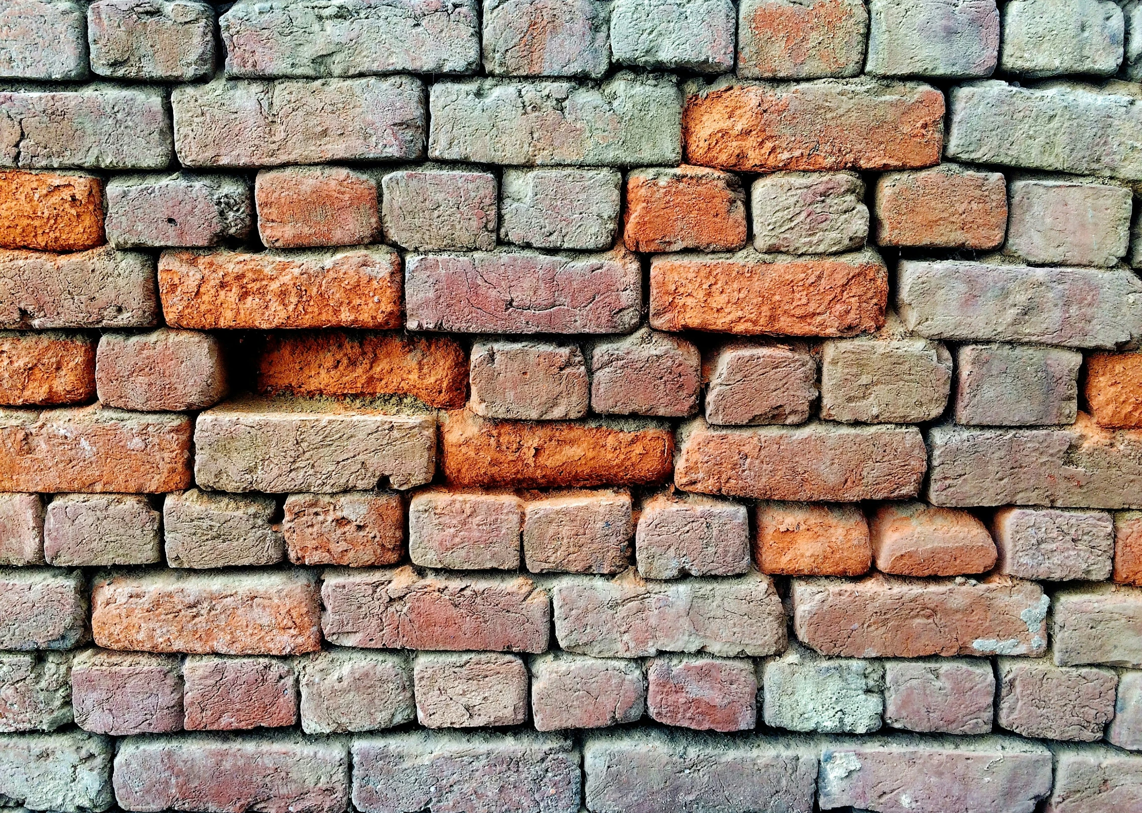 a brick wall in an orange - colored concrete texture