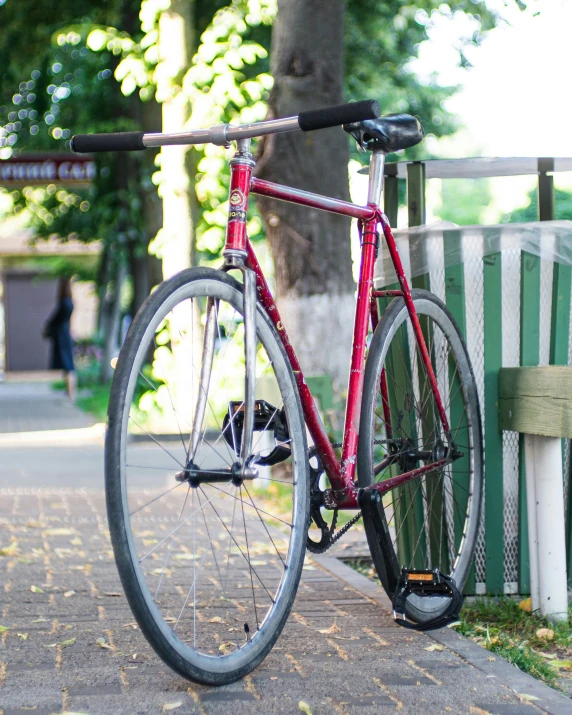 a bicycle leaned up against a bench on the street