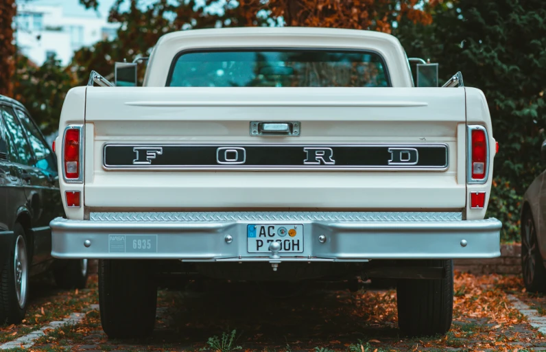 a pickup truck parked with other vehicles behind it