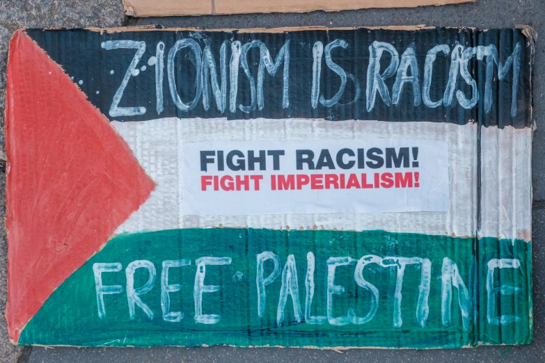 an anti - racism sign with the word free palestine written on it
