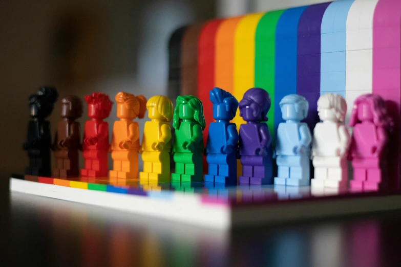 a row of small colorful toy figurines on top of a table