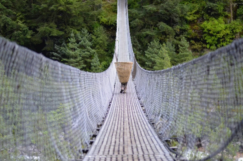 a suspension bridge spans over a mountain river