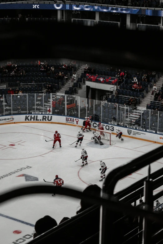 people are watching a hockey game from the stands