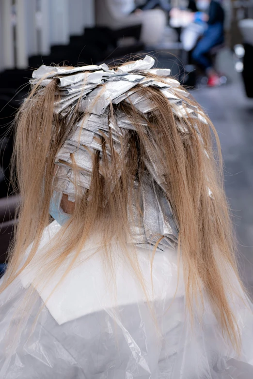 the top part of a human head with a bunch of plastic hair