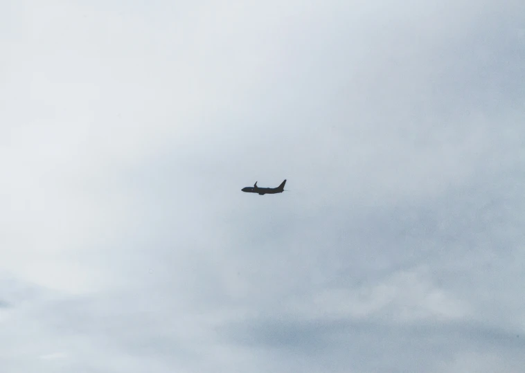 a plane is flying through the sky