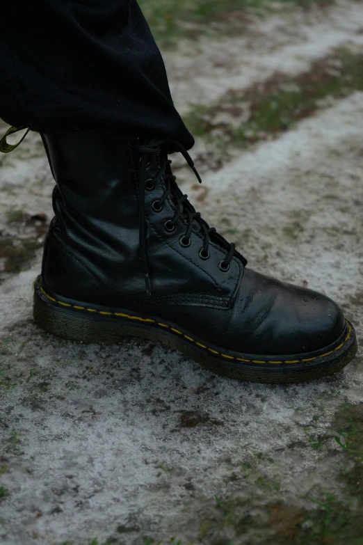 a person's black shoes and boots are all black