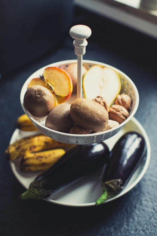 a serving tray with fruits and vegetables sitting on a table