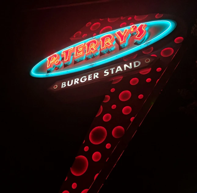 a neon sign that says itty bitty's burger stand