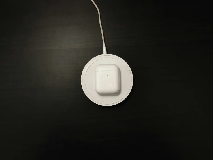 a black table with an oval white device sitting on it