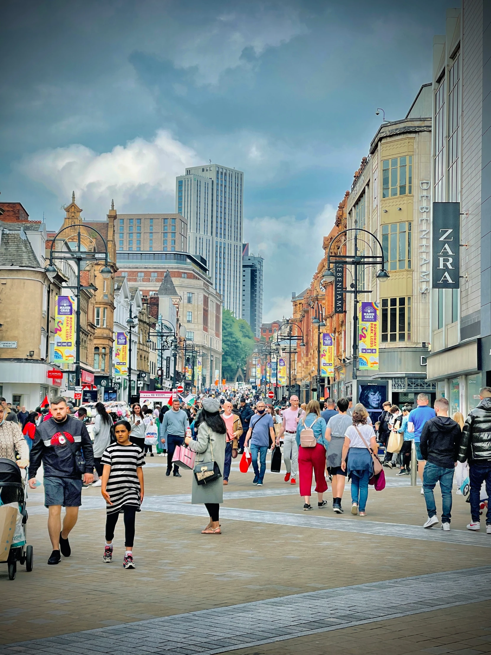 many people walking in the streets of a city