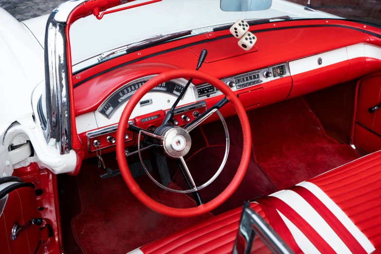 the inside of a car with white and red leather