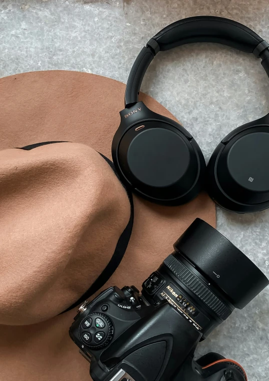 a hat and camera on the ground