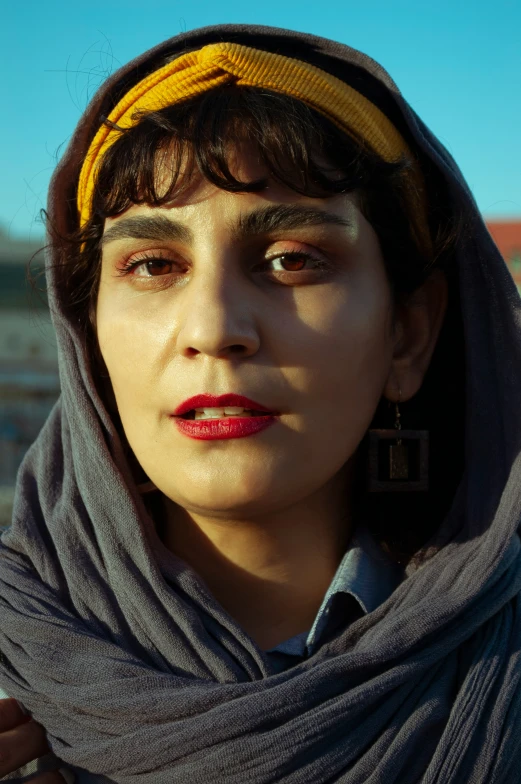 an image of a woman in a headscarf with freckled hair