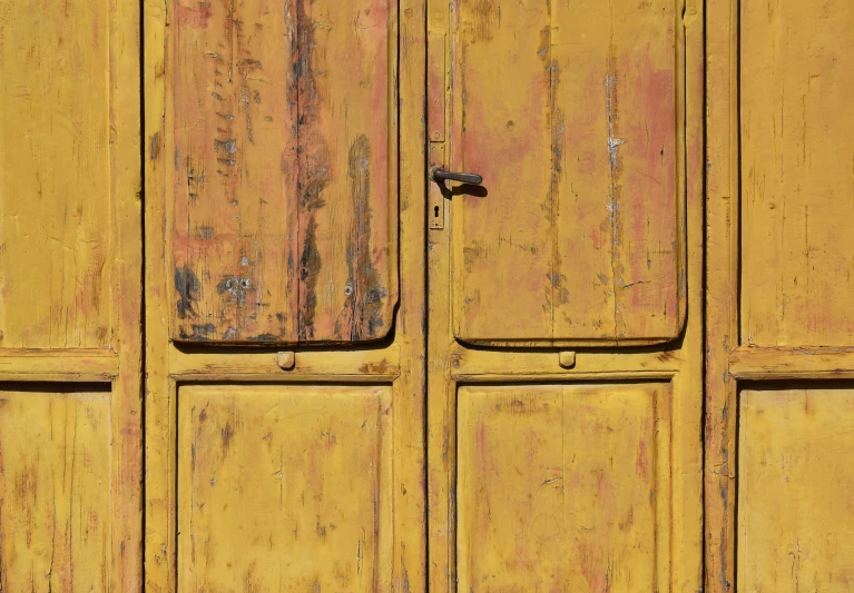 a wall with yellow paint with the doors closed