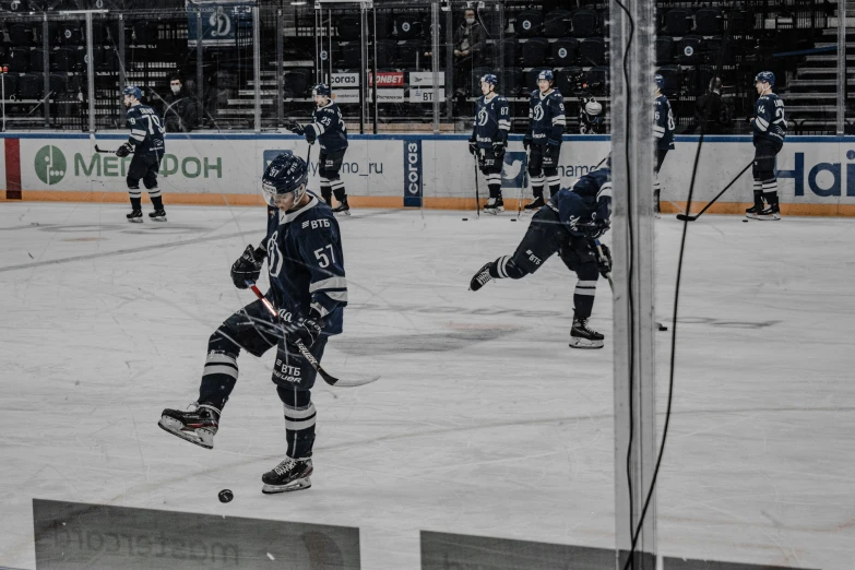 two men playing ice hockey in front of fans