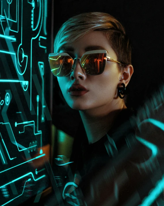 a woman with sunglasses next to a blue neon wall